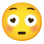 وجه مبتسم مع عينين على شكل قلب + وجه متورد
