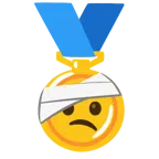 medaglia d’oro + faccina con la testa bendata